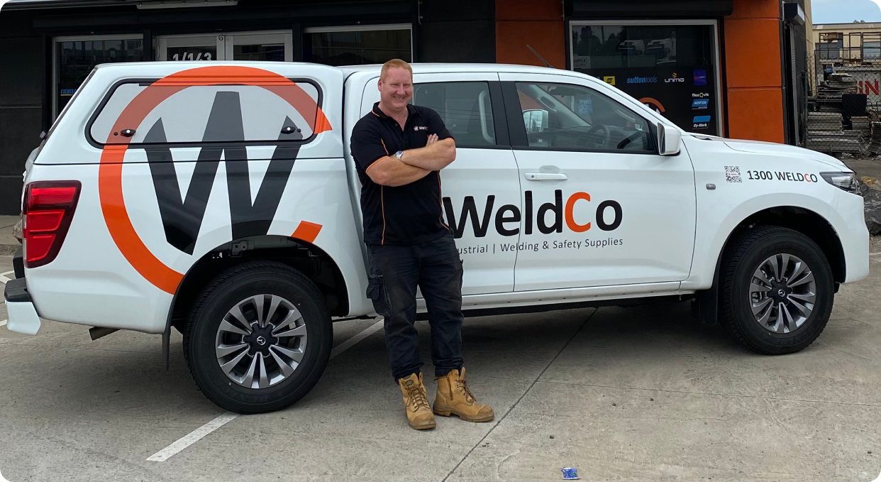 WeldCo Employee in Front of Car